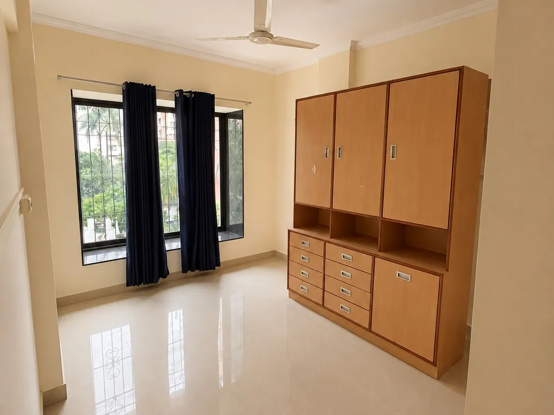 Living room with wardrobe unit in a 3 BHK flat for rent in Chembur
