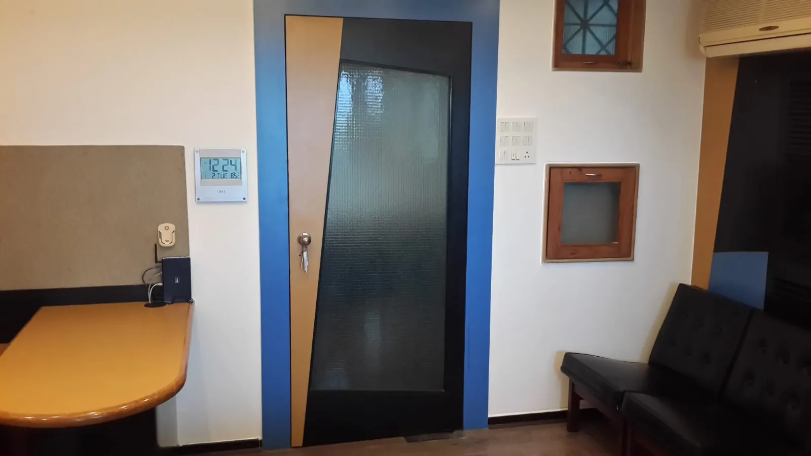Workstation and glass-panel cabin door in a Chembur office